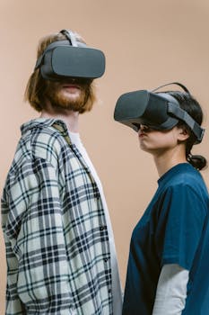 Two young adults wearing VR headsets, enjoying immersive technology experience indoors.